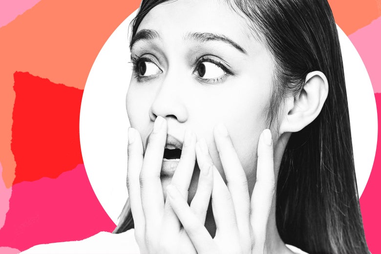 A young woman with her hands over her mouth, looking shocked.